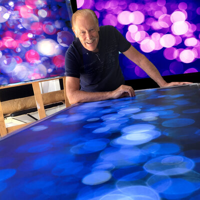 Bruce Peebles in the Studio: Surrounded by some of my Sun Glitter series artworks. The foreground blue artwork (sold by Singulart) now resides in Paris, France, top left artwork resides in Toowoomba, Australia, top right (Dancing in the Shadows) is available through Singulart