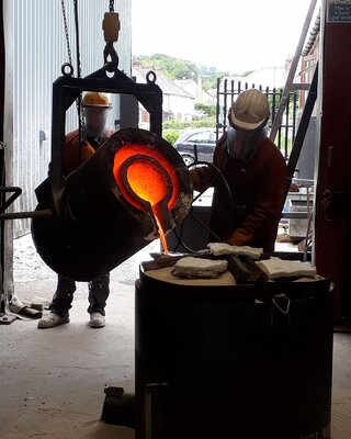 Barry Davies RCA in the Studio: Pouring molten bronze into a ceramic shell.