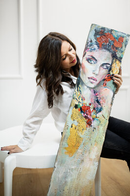 Sylwia Kalinowska in the Studio: From the heart of my studio, I stand before the rustic painted board—a silent witness to the passage of time. These boards, once part of old cottages and weathered fences, now find new purpose under my brush. They bear the weight of stories, etched i