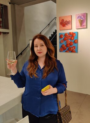 Jane Lantsman in the Studio: At the exhibition "The salt of the earth. Food in Israeli Art", 2023, Bnei Brak. I'm syanding with two of my artworks (Pomegranates and Cherries) behind me.