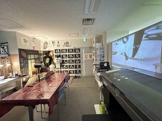 calligrapher MADARA in the Studio: MADARA Atelier welcomes visitors and offers calligraphy experiences.