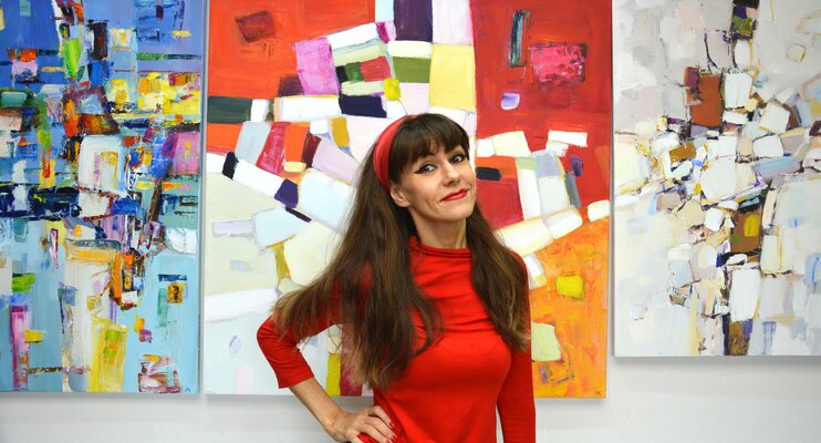 Iryna Kastsova in the Studio: Photo in the studio. Against the background of abstract works.
