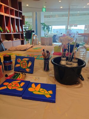 SAORI TRIBE in the Studio: A view of my temporary studio during an artist-in-residence program at a hotel. This is the live creative space where I bring my vibrant characters to life in an open, light-filled environment.