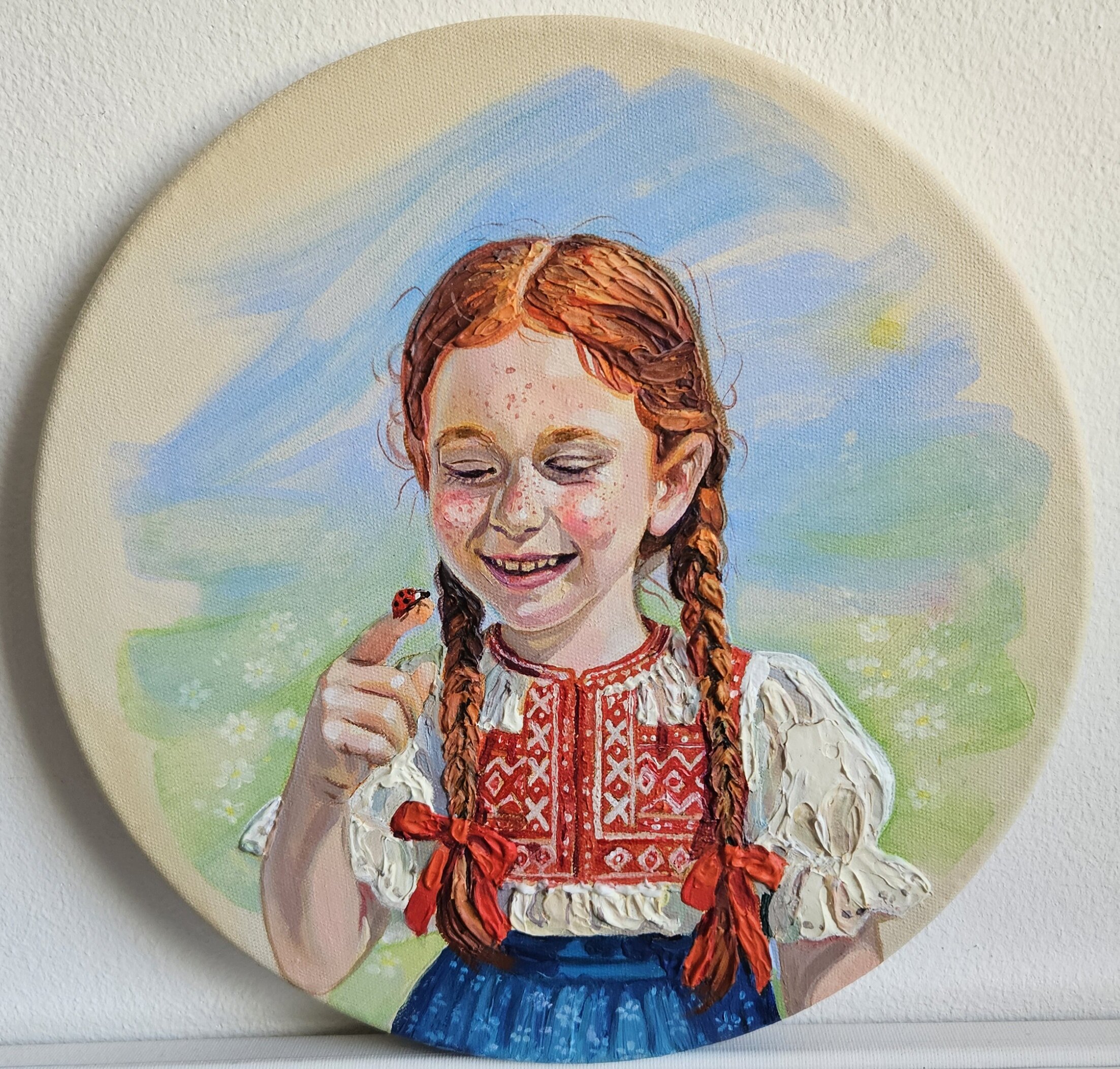 A redhead girl with a ladybug